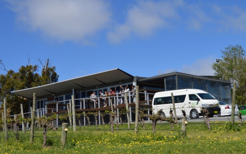 Des's Minibus with a 13 seat vehicle in front of an Adelaide Hills winery.