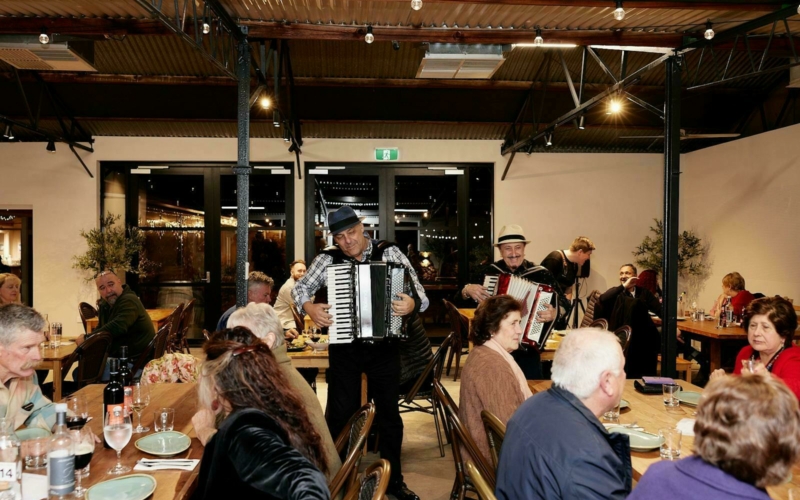 Image of The Sopranos and guests eating and enjoying entertainment